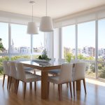 Modern dining room with large windows and a stylish table setup.